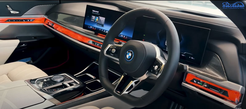 The front-interior view of a BMW I7 sedan.