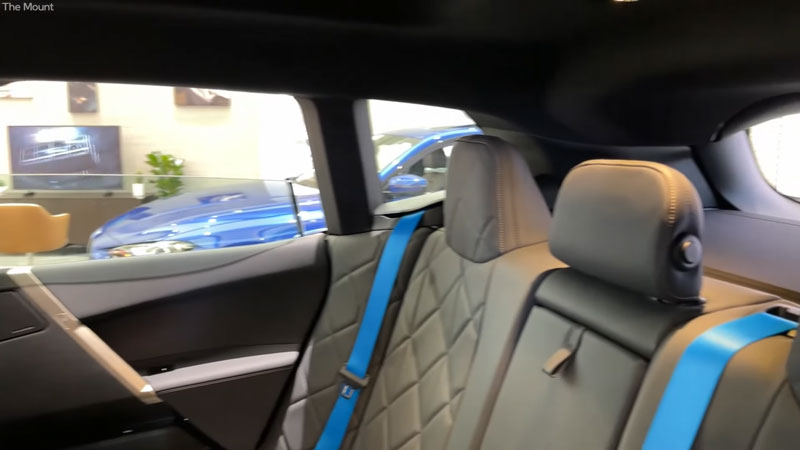 The rear-interior view of a 2021 BMW Ix SUV.
